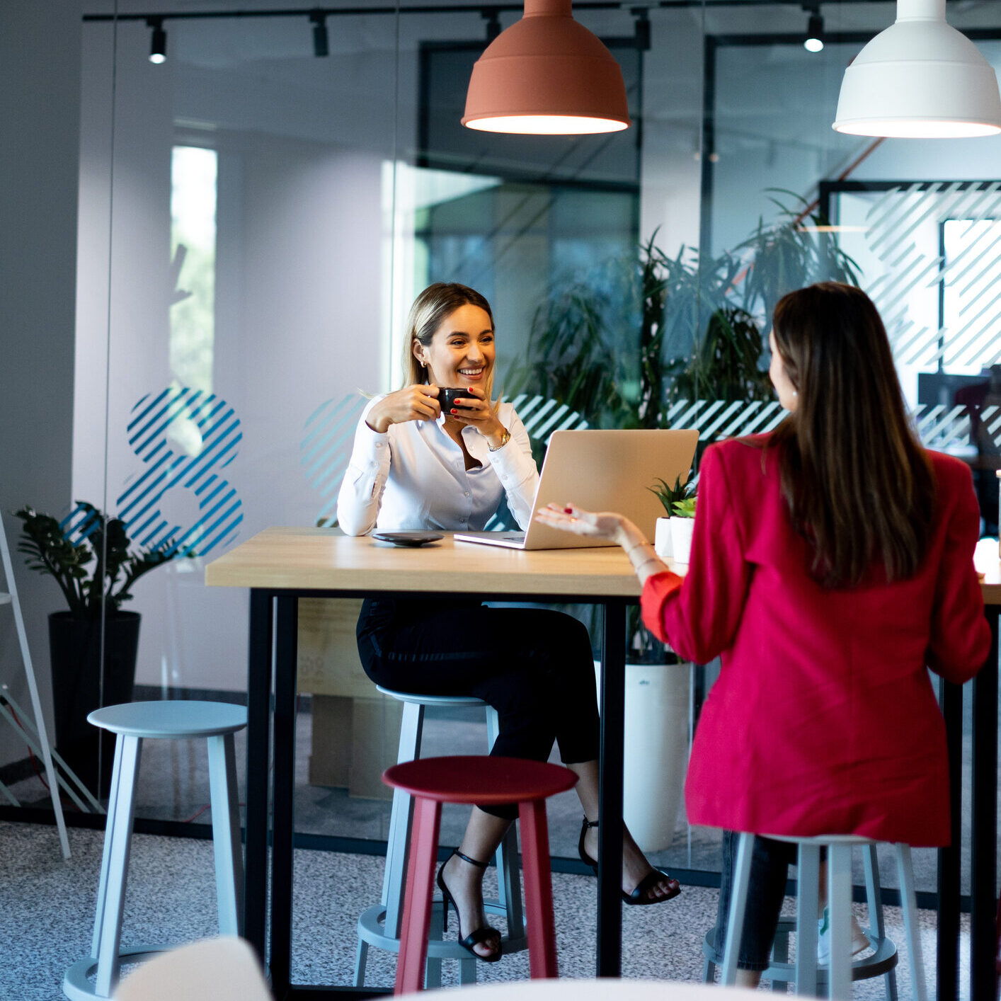 Dallas Staffing Agency Employer client is seen meeting with new temporary staff staff member and smiling with a cup.