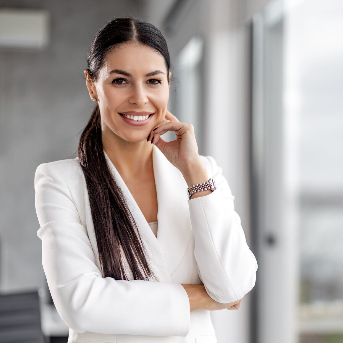 Scion Staffing Dallas Recruiter female in white suit with hand on chin smiling at work